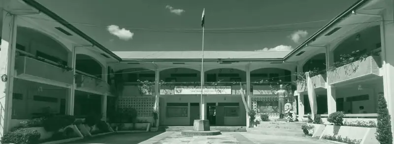 The TNCHS main courtyard with the flagpole and the two-storey arcaded buildings